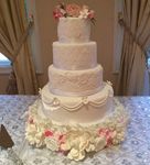 White wedding cake with laces and flowers